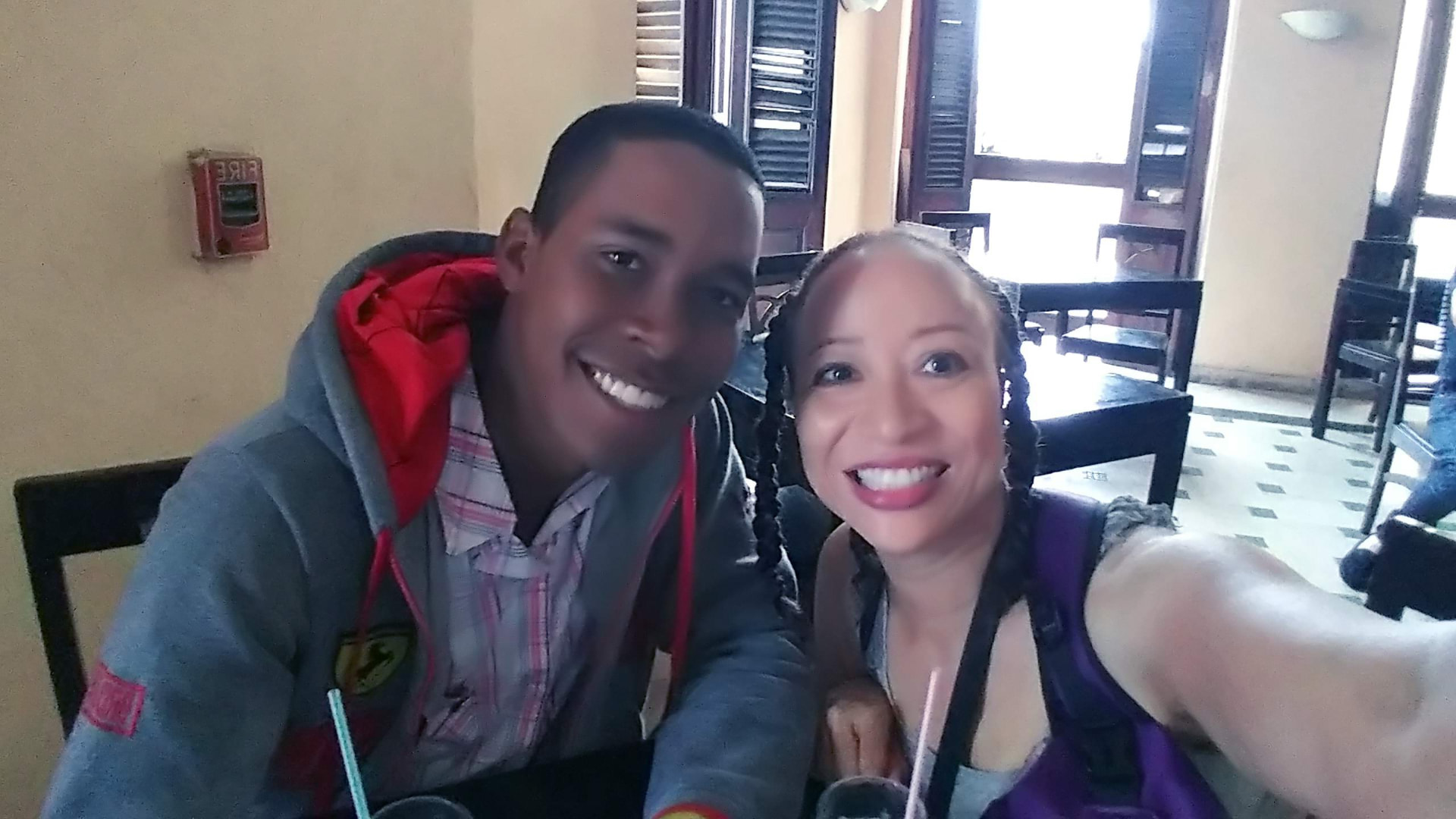 Allison smiling with a companion inside a Havana cafe