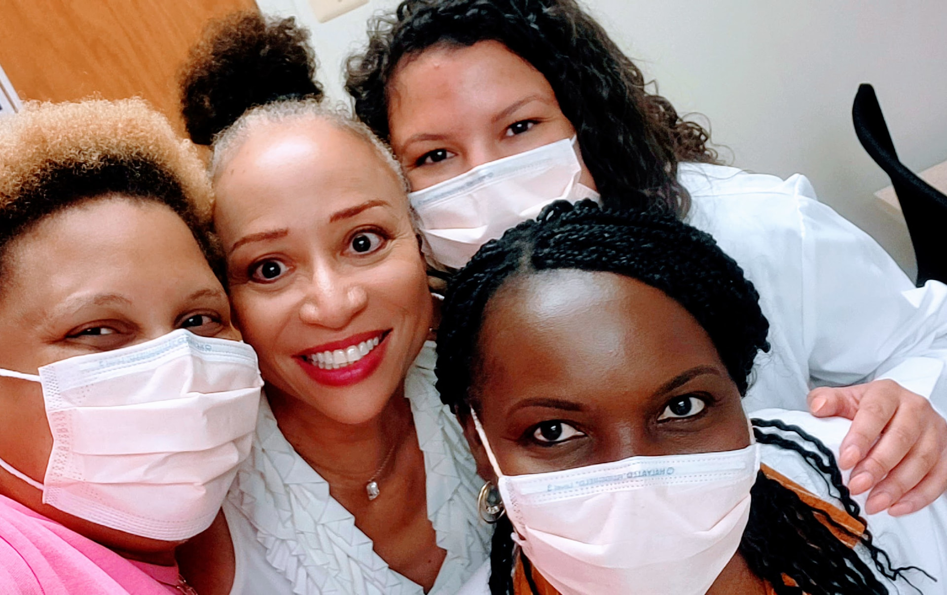 Allison Kalloo with colleagues in masks during an NIH sickle cell study
